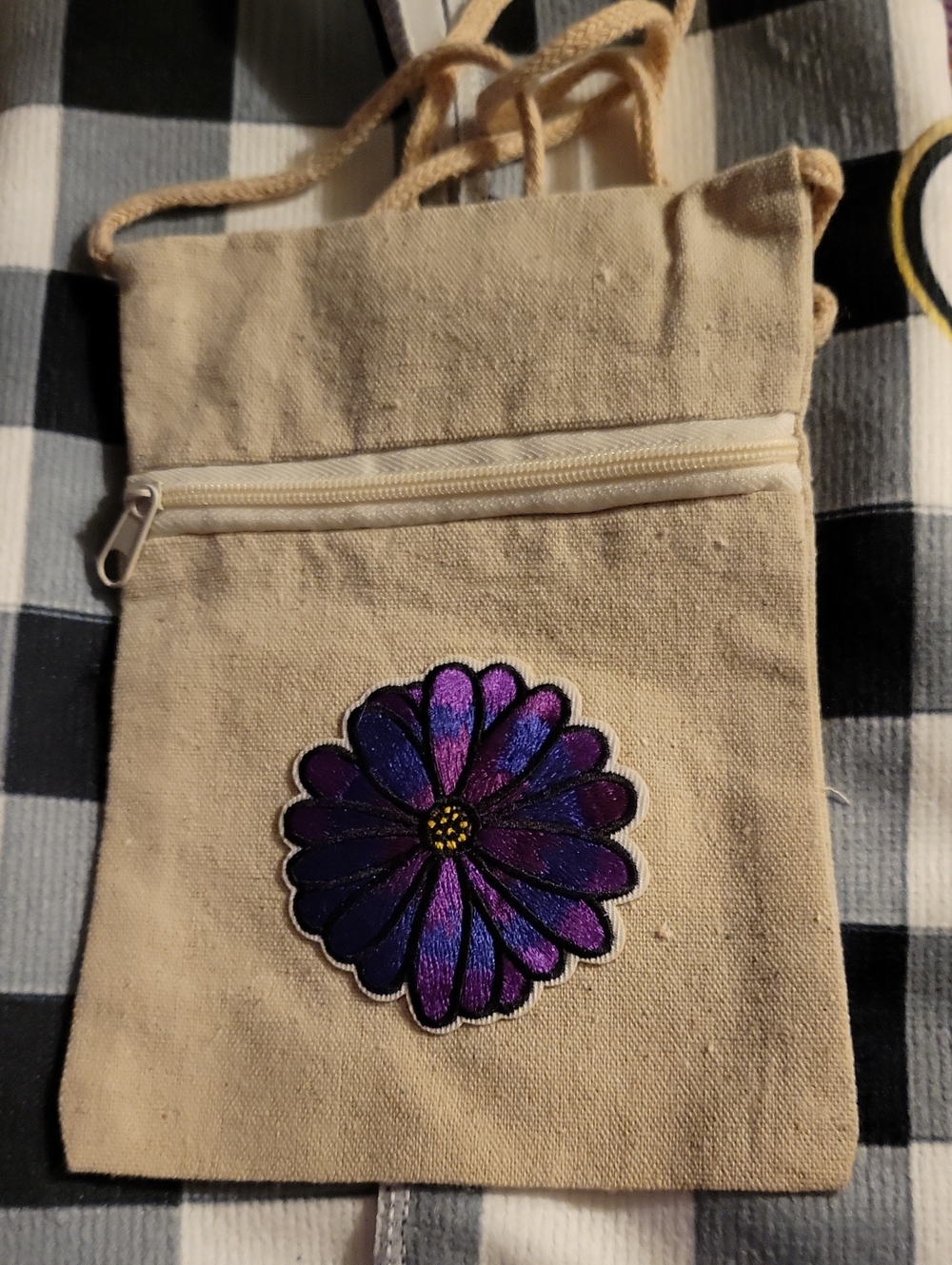Canvas Crossbody Bag with Purple Floral Patch And Floral Bracelet.